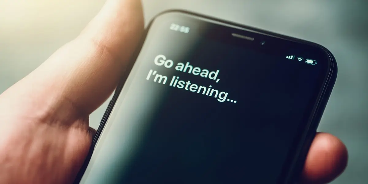 A person holding a mobile phone with the phrase displayed: Go ahead I'm listening