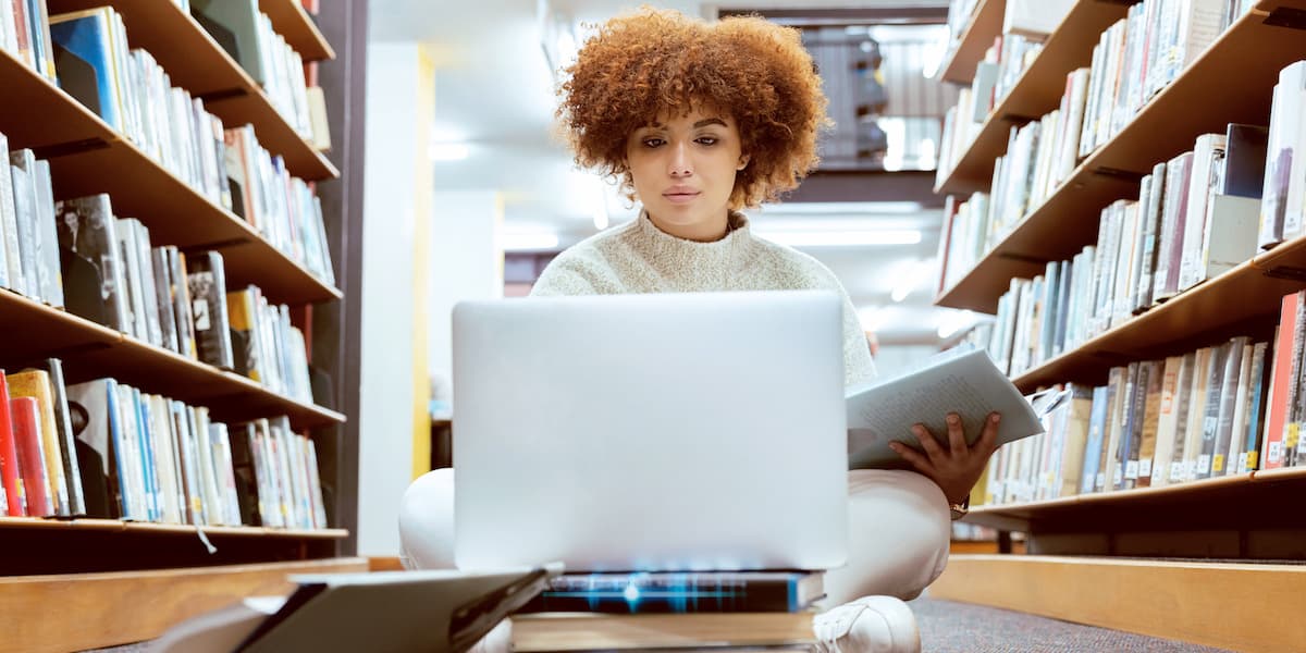 a young woman studying tech