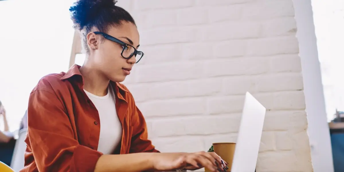 A data analyst working on a laptop