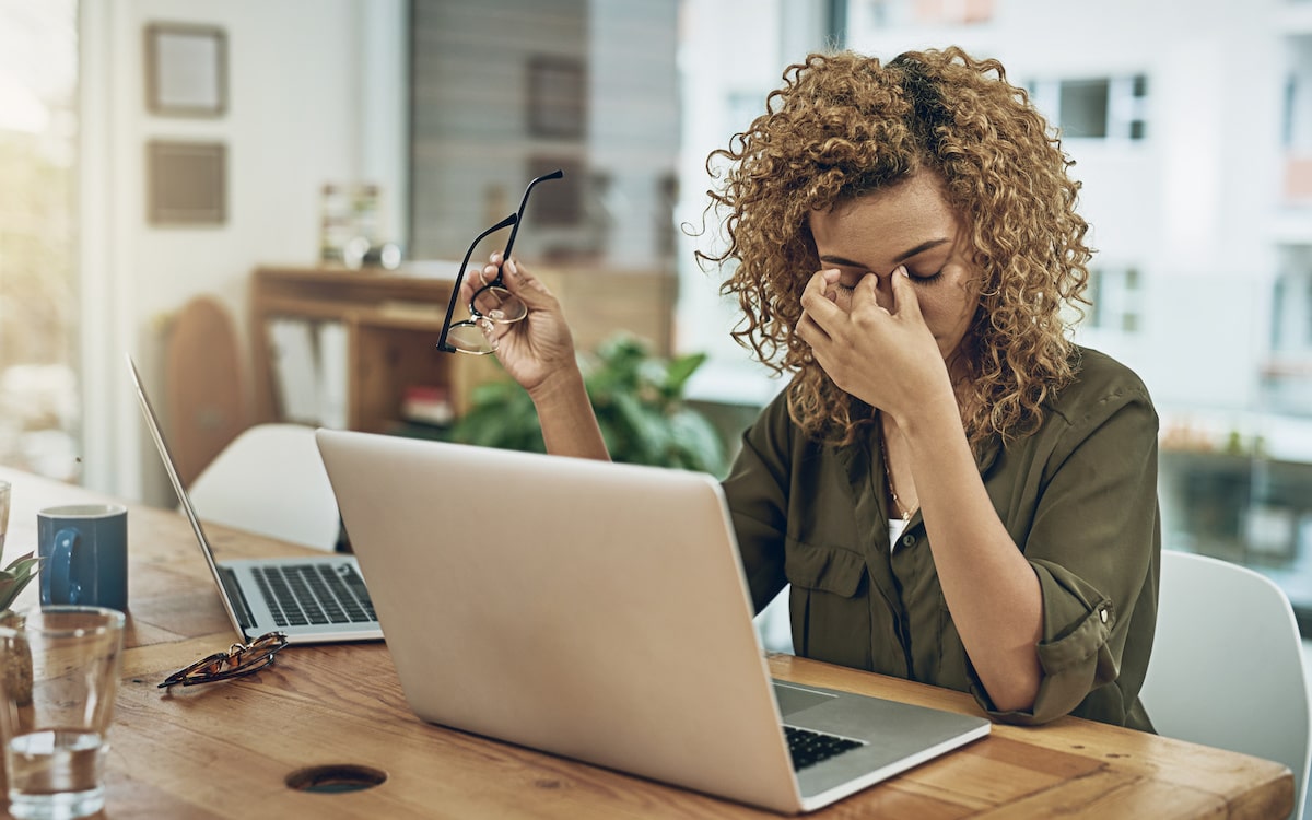 A frustrated developer pinches her nose after finding an AWS security mistake.