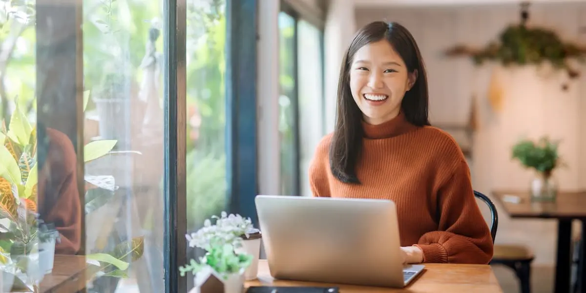 Young student sitting at laptop choosing between different IT online certifications