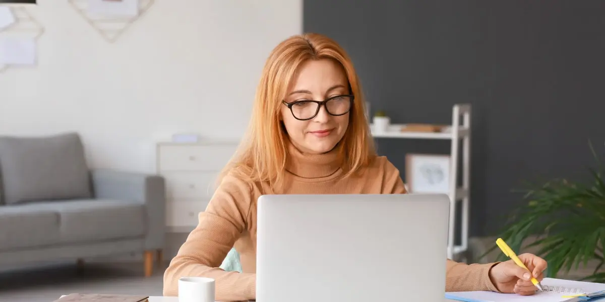 A remote web developer sits at a desk using a version control system