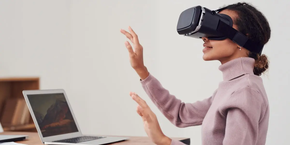 A UX designer standing in an office, wearing a VR headset