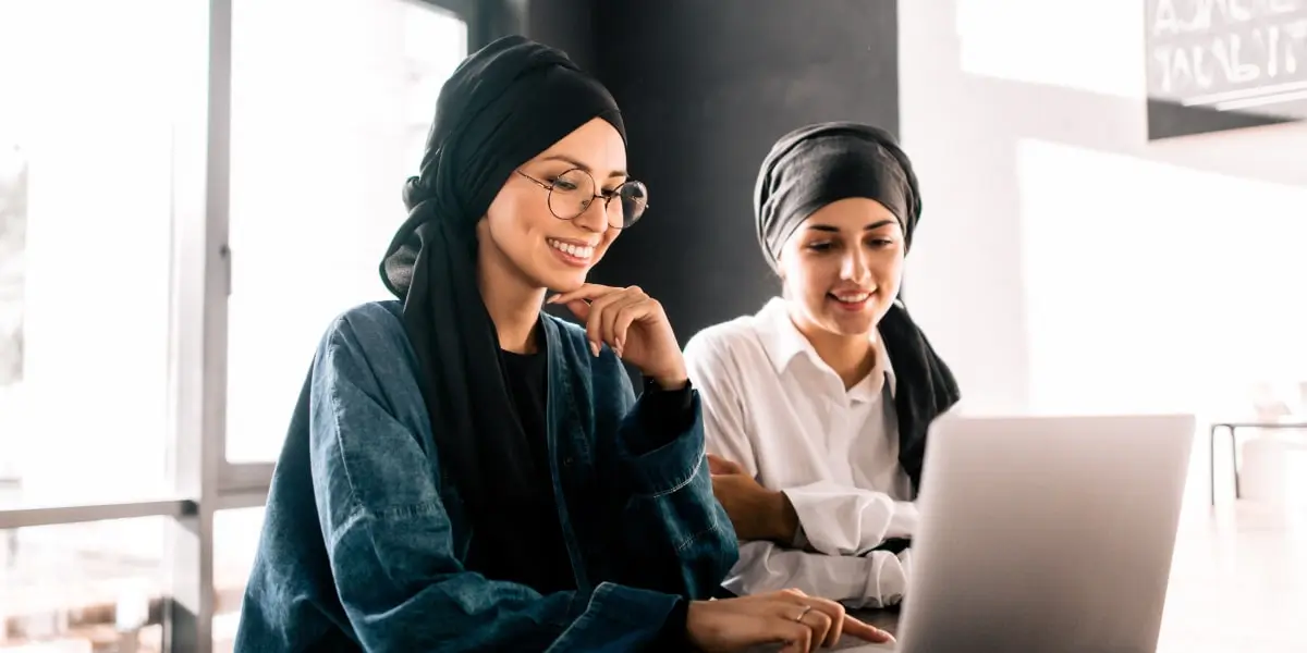 Two UI designers sitting side by side at a desk