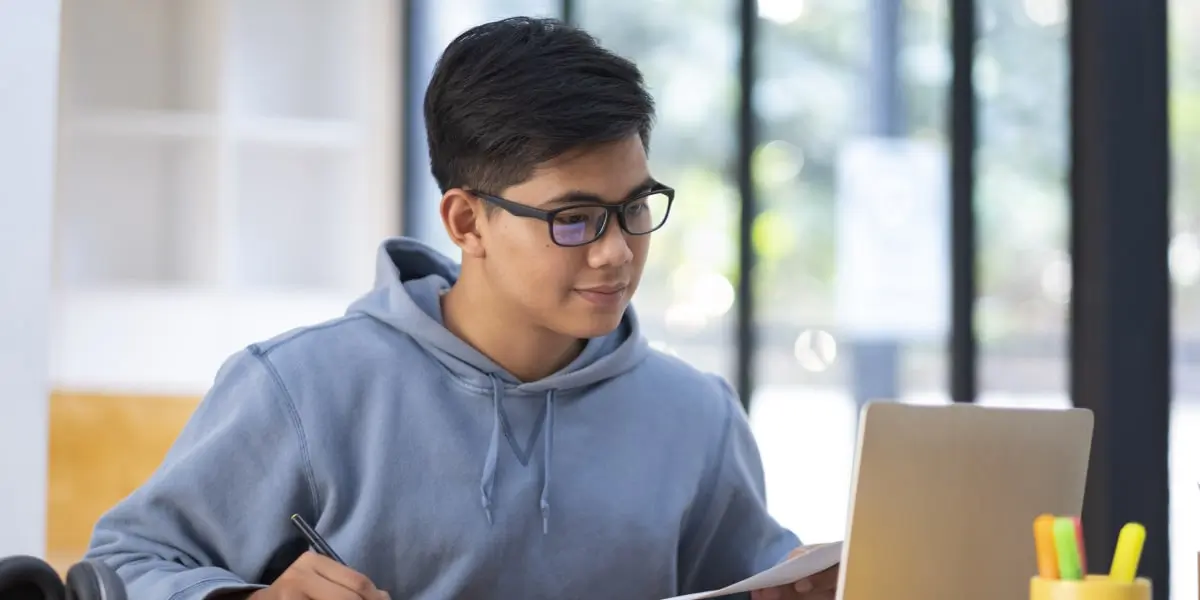 A data science bootcamp student working at a laptop