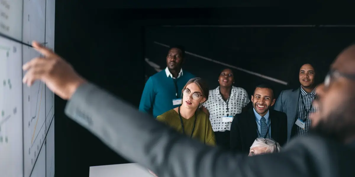 A group of data analysts looking at a graph