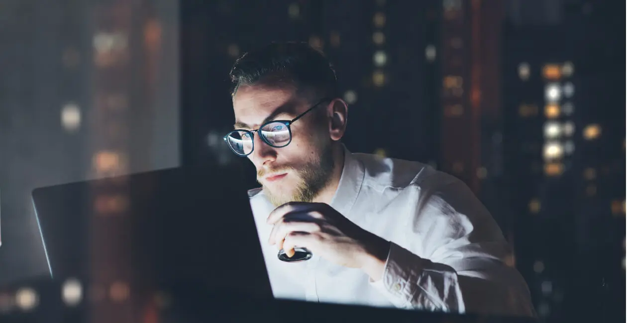 A UX designer working on his portfolio in a dark room