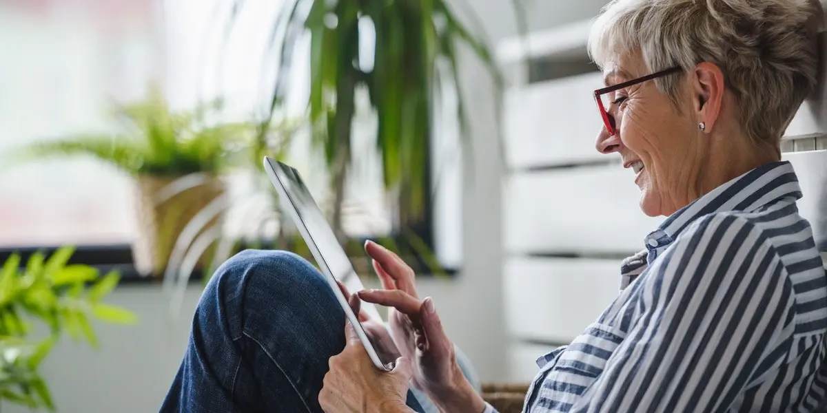 An aspiring UX designer sitting on a bench, working on her tablet