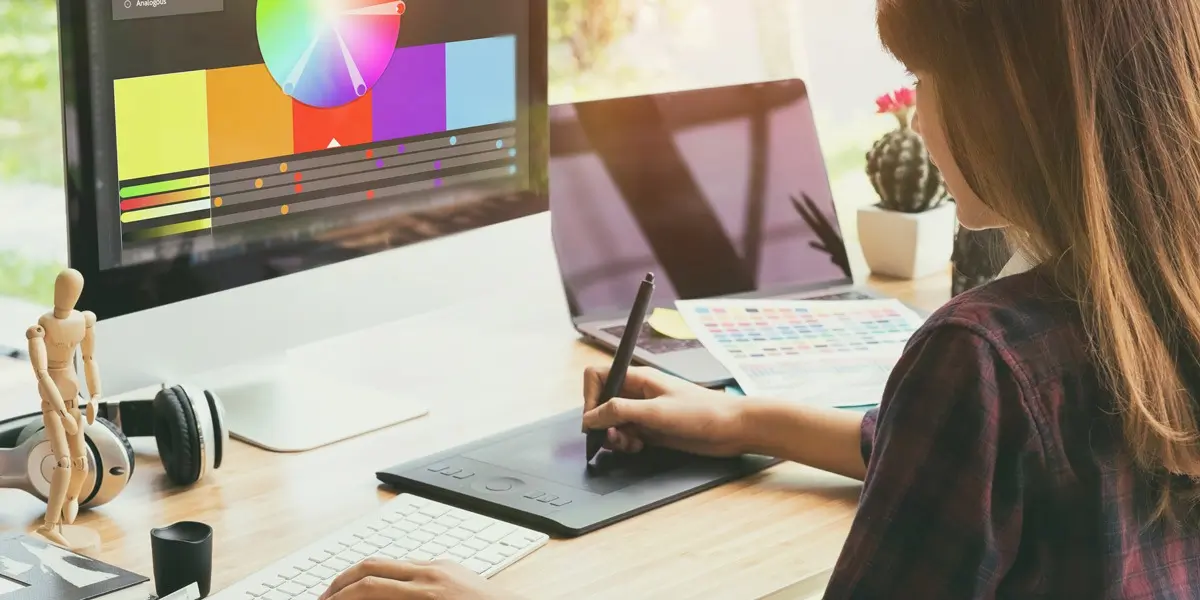 A UI designer in side profile, working on a computer