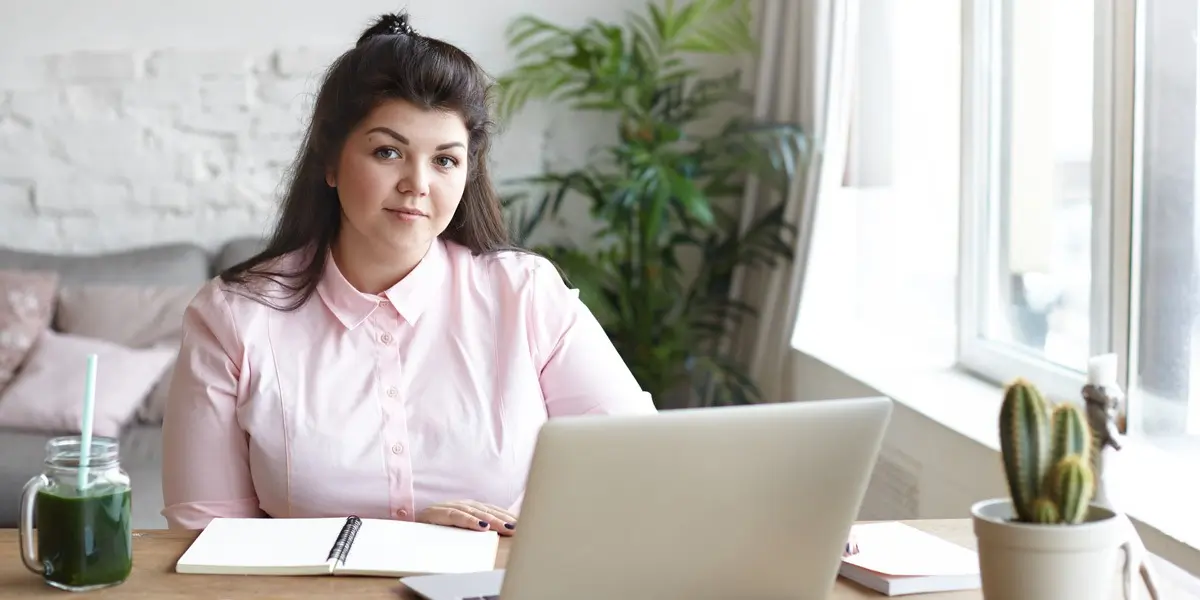 A data analyst sitting at a desk with a laptop