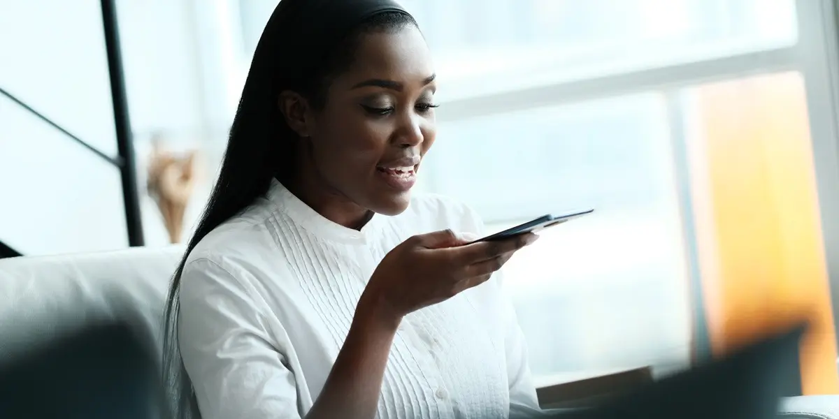 A data analyst speaking into a mobile phone