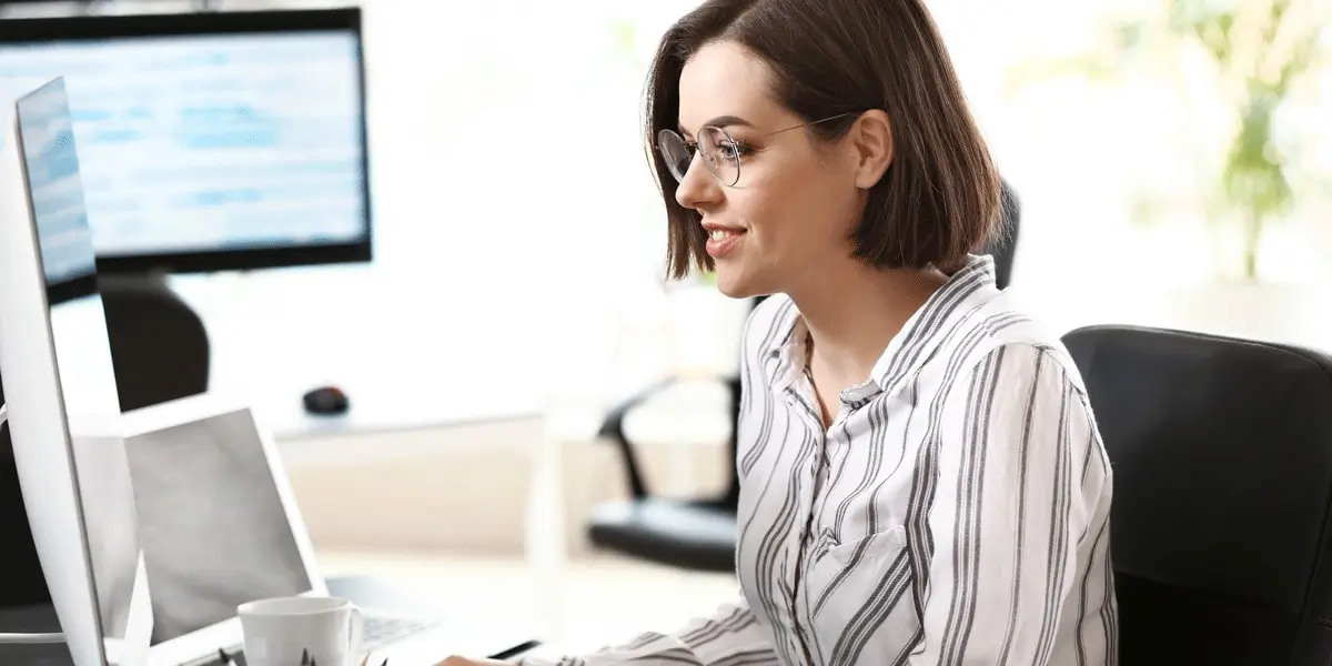 Female JavaScript developer working on code in an office