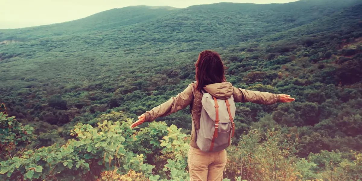 A digital nomad looking out over a scenic mountain view