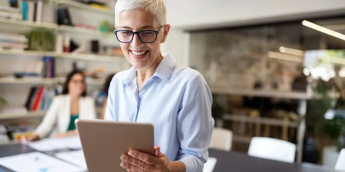 A data scientist looking at a laptop screen, smiling