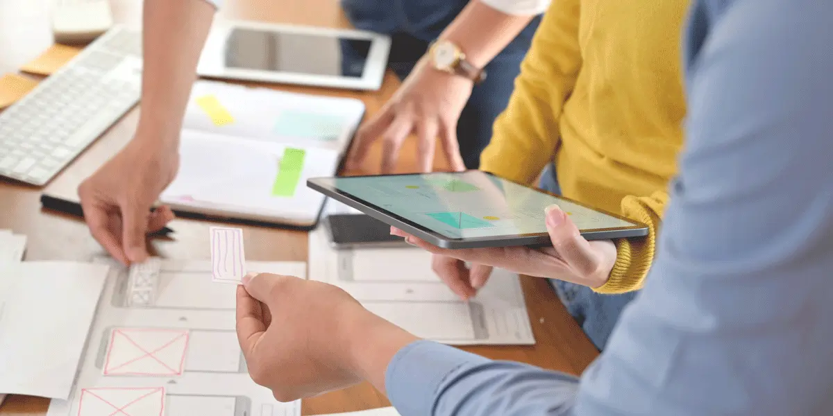 A group of designers gathered at a table, building a rapid prototype