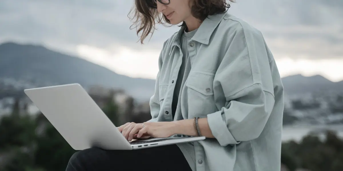 A remote UI designer working on a laptop