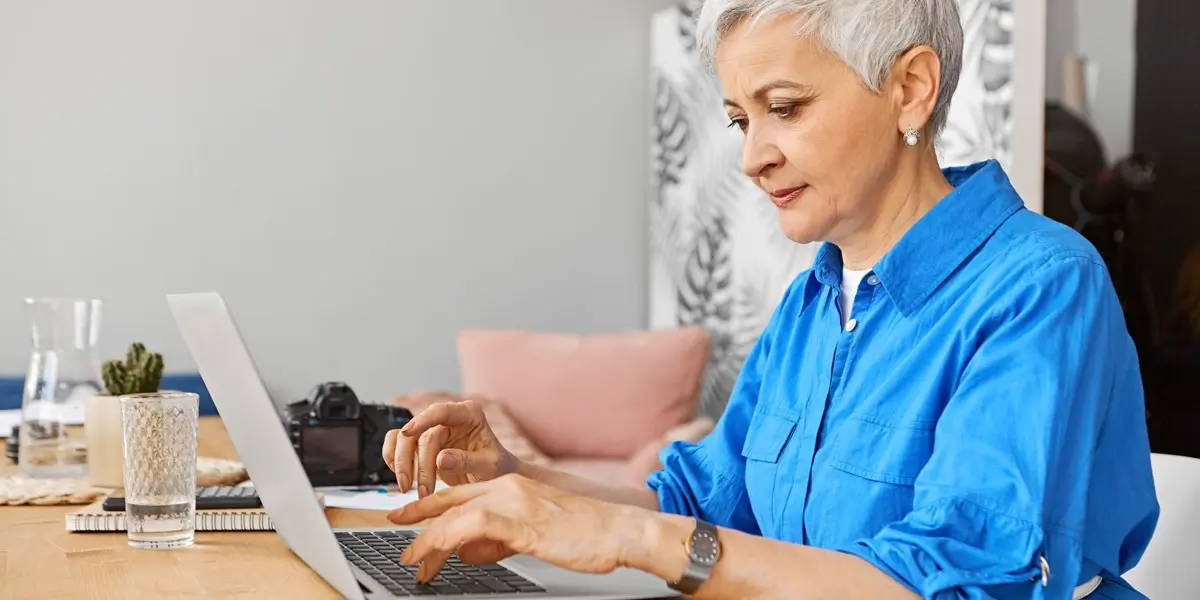 A UX designer sitting at her desk, working on a laptop