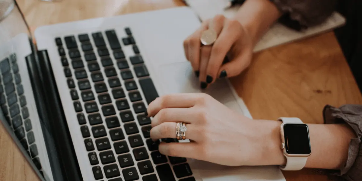 A UI bootcamp student typing on a laptop