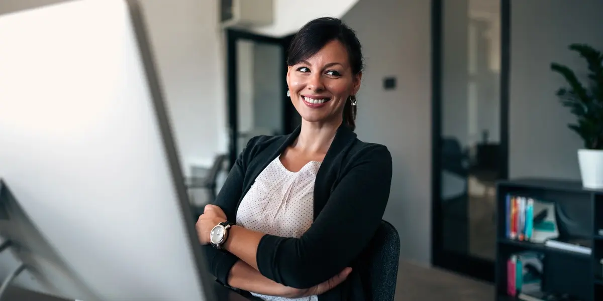 A designer standing at a whiteboard easel