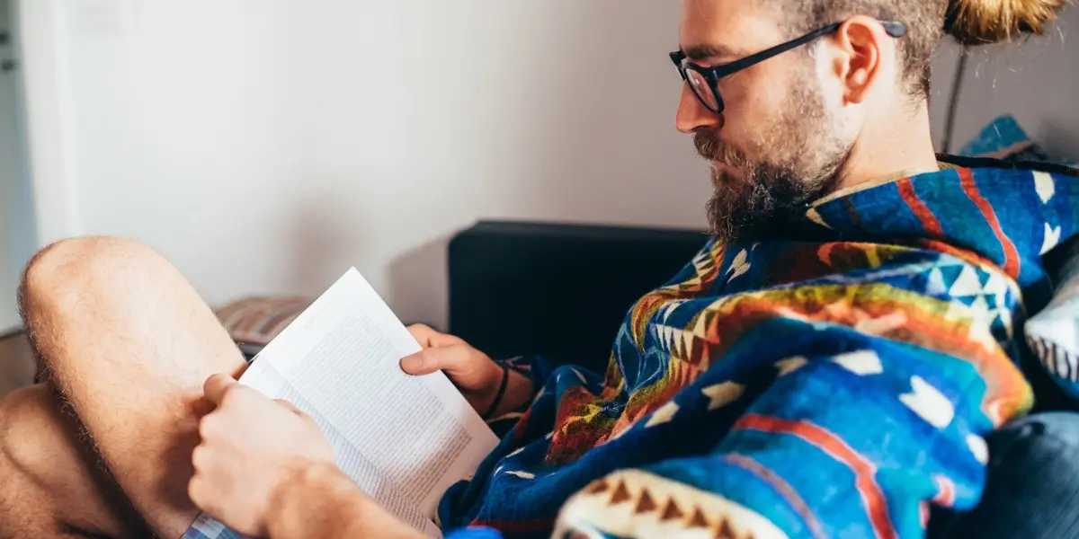 A designer sitting in a comfy chair, reading