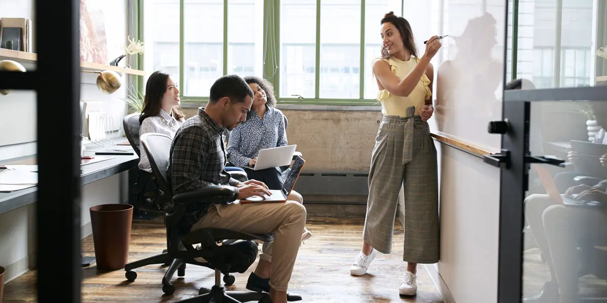 A UX researcher presenting findings from her portfolio to a group