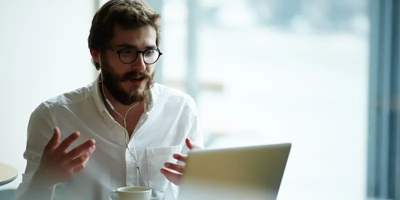 A UX designer conducting a user interview over their laptop