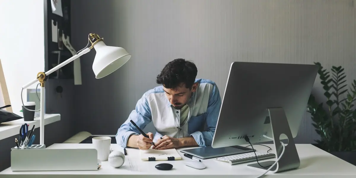 A full-stack developer working at a computer in an office.