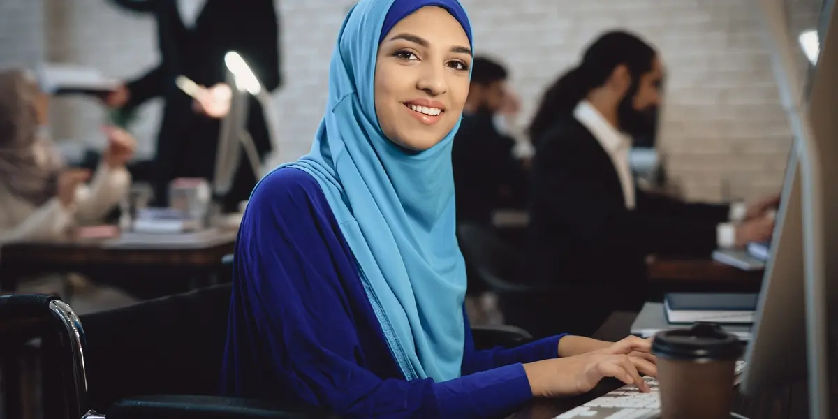 A data scientist smiling, typing on a keyboard