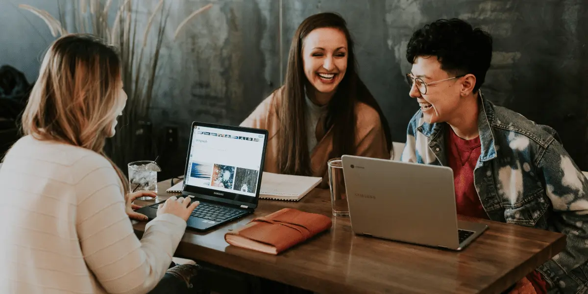 Three data analytics students working in a cafe