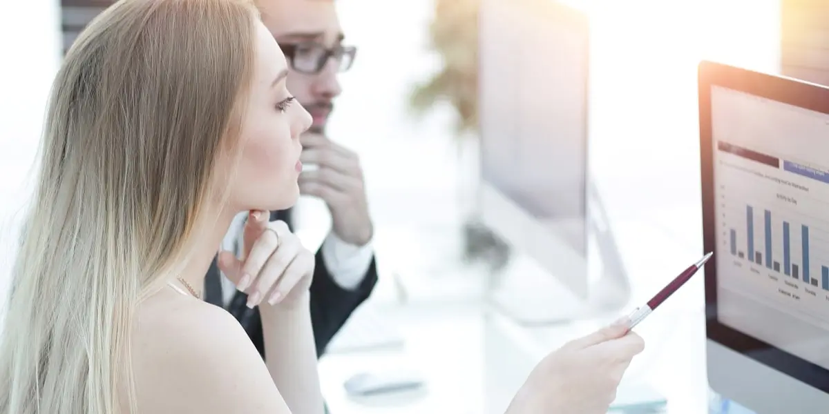 Two data analysts in side profile looking at Bernoulli distribution on a screen