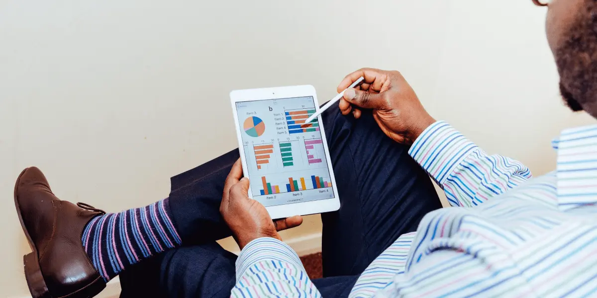 A data analyst looking at data visualizations on a tablet