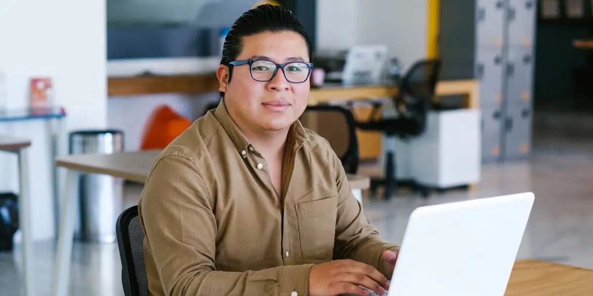 A data analyst sitting at a desk with a laptop