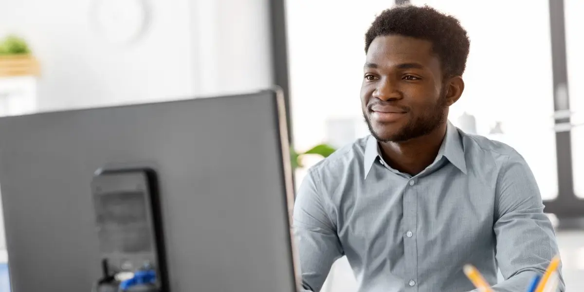 A data scientist working on a desktop computer