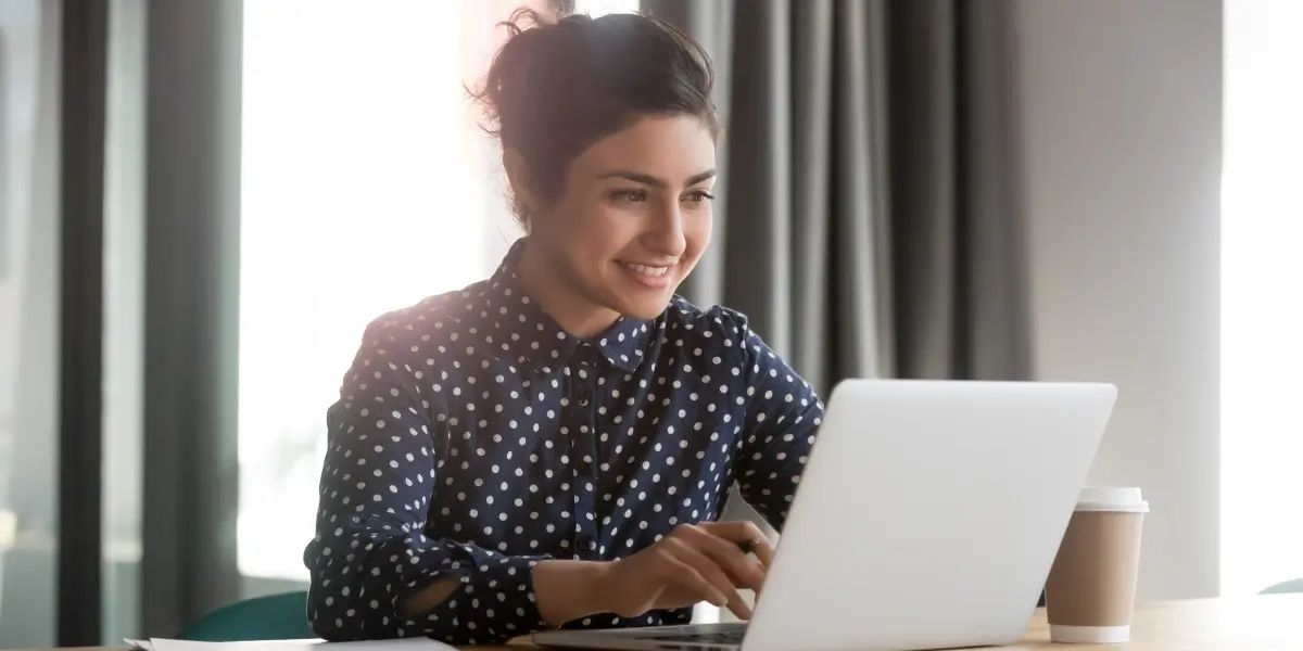 A data analyst working through data on a laptop