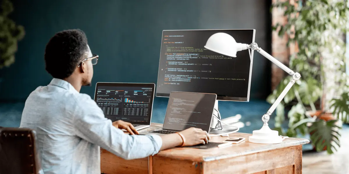 A coder working at his job in tech in an office.