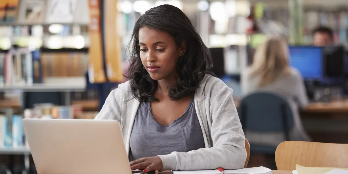 Do you need a degree to become a UI designer? An aspiring UI designer sitting at a desk with a laptop