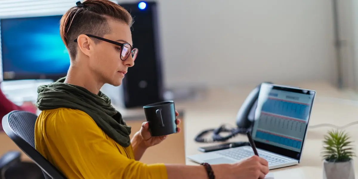 A data analyst in side profile, inserting the Delta symbol in an Excel spreadsheet