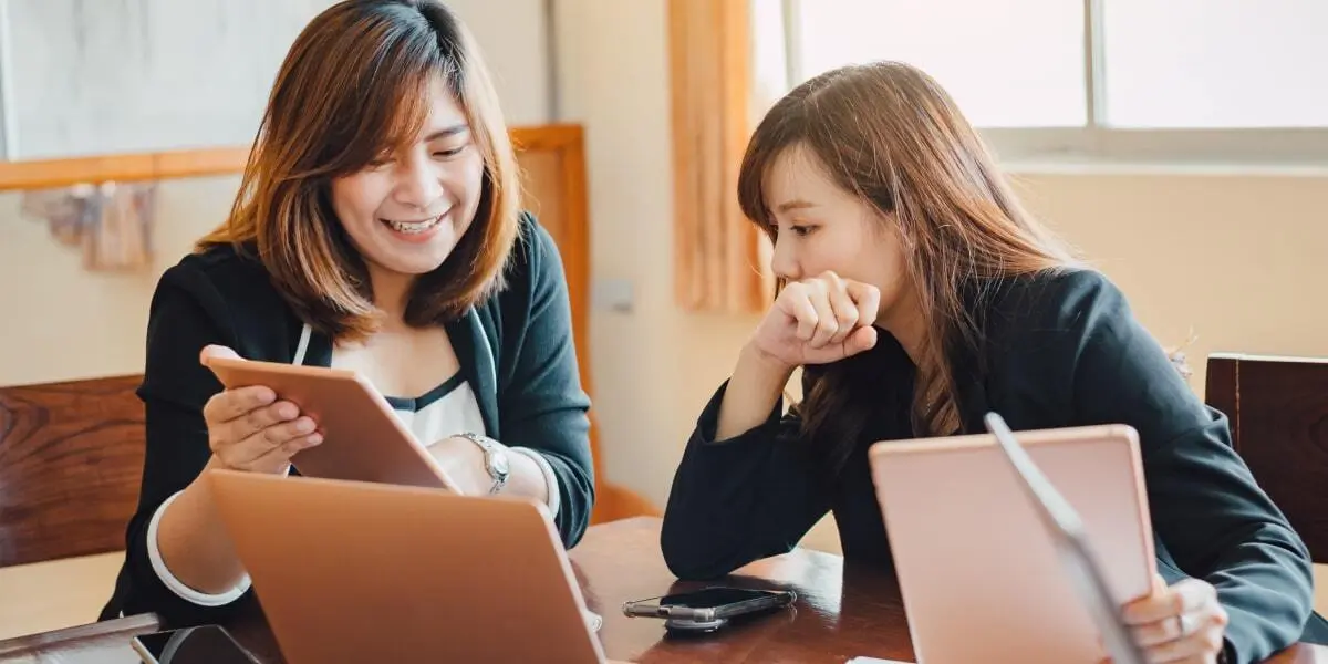 Two entry-level data analysts working together