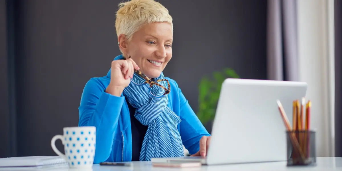 A person typing on a laptop, researching the top digital marketing jobs