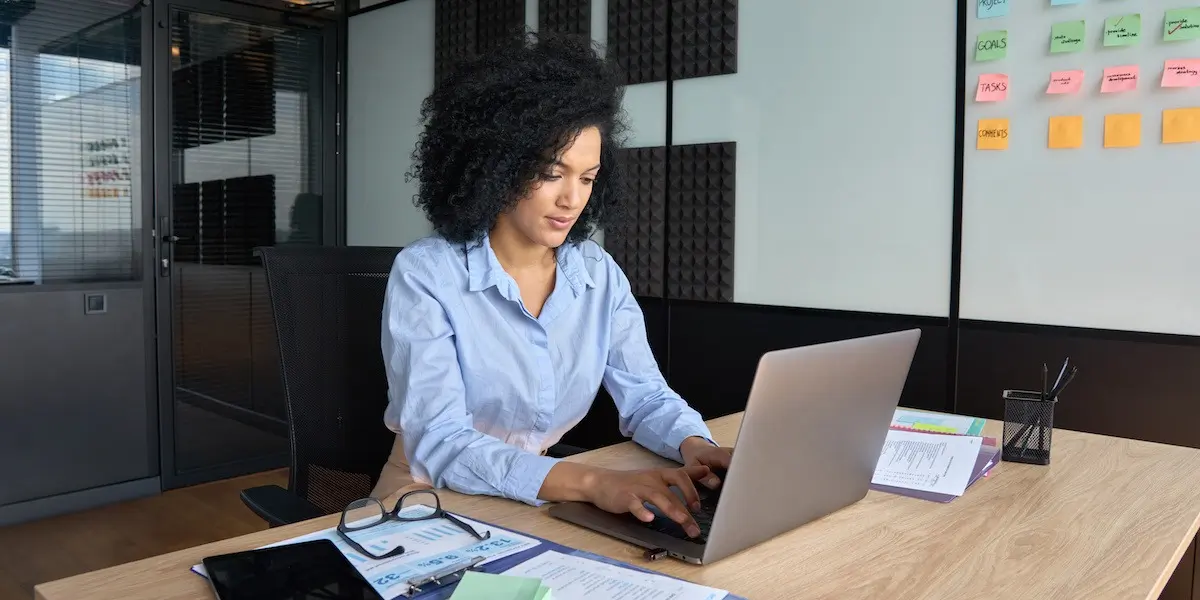 Data analyst working on a laptop in an office