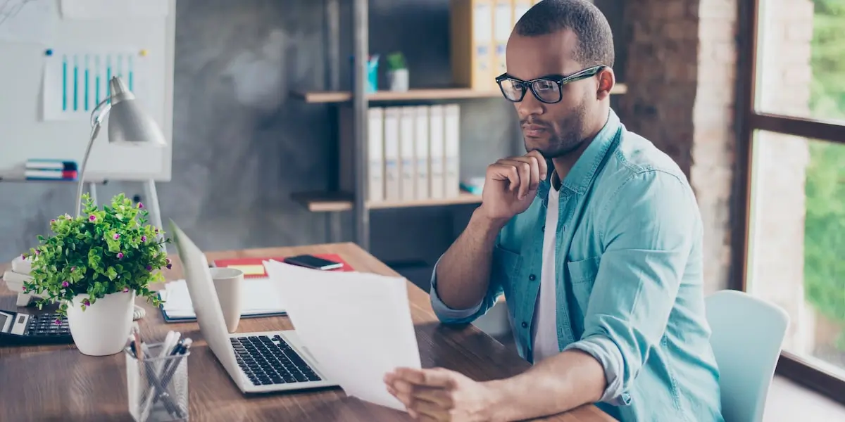 Data scientist studies visualizations on paper in their office