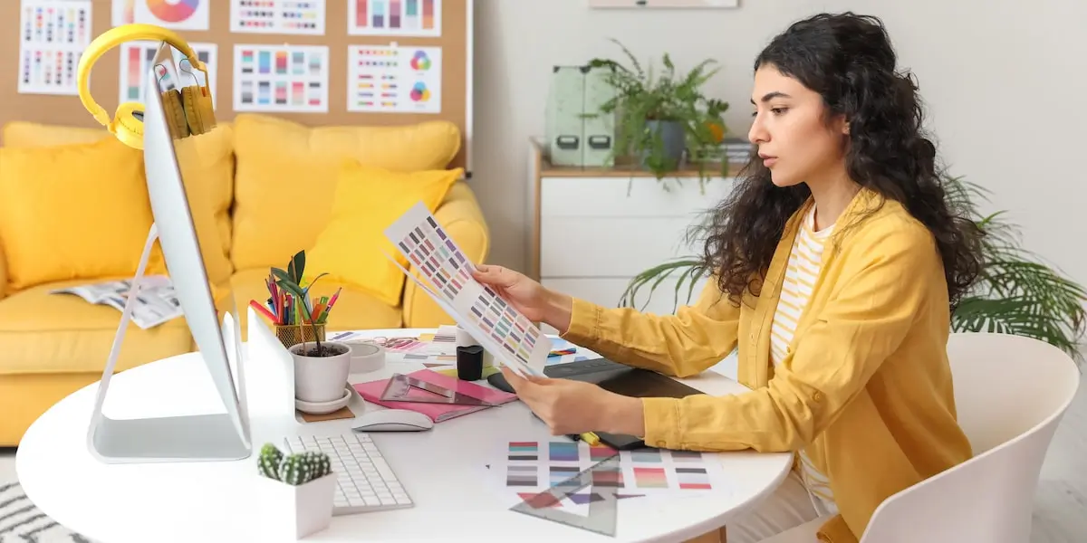 UI designer at her desk working to apply Fitts's Law to color swashes.