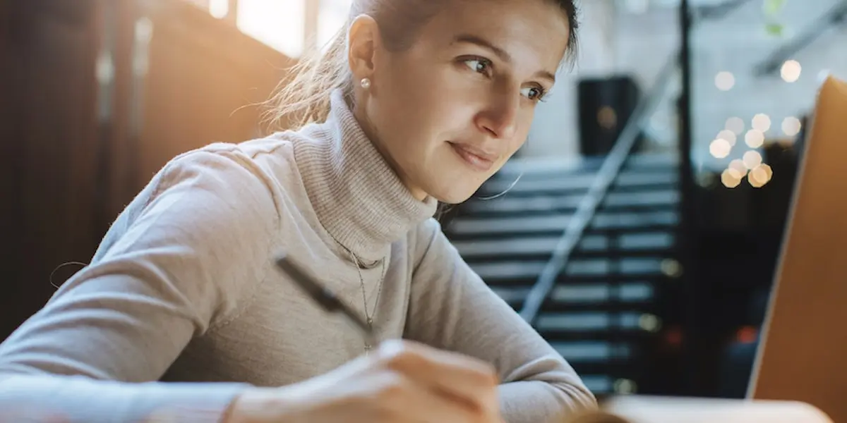 young woman creating a tech resume from an online guide