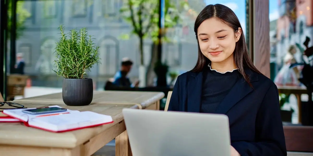 Person working on a social media marketing strategy from an outdoor table