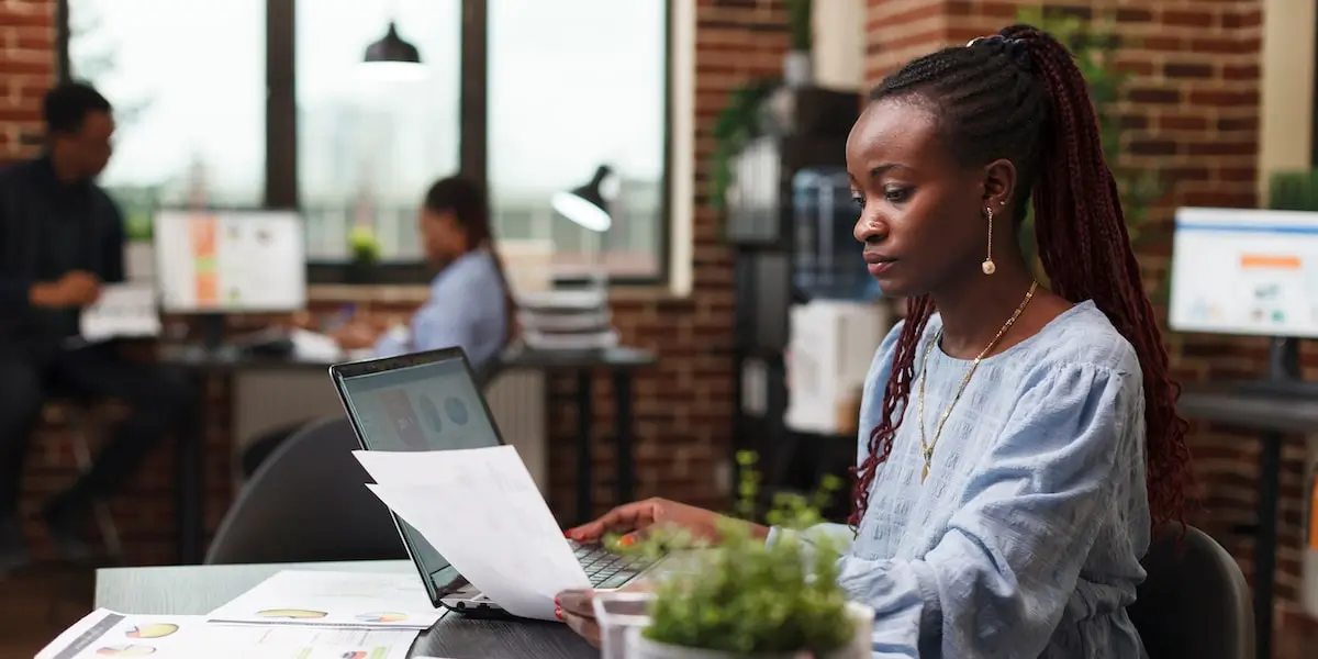 A woman working through the data mining process in an office