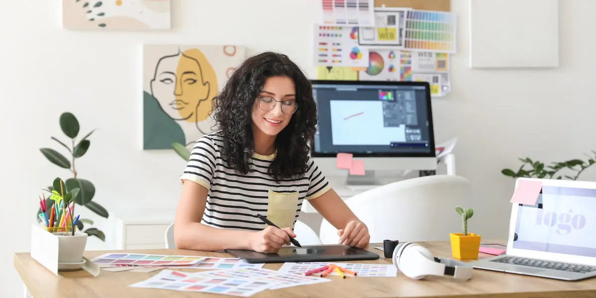 graphic designer sitting at desk working