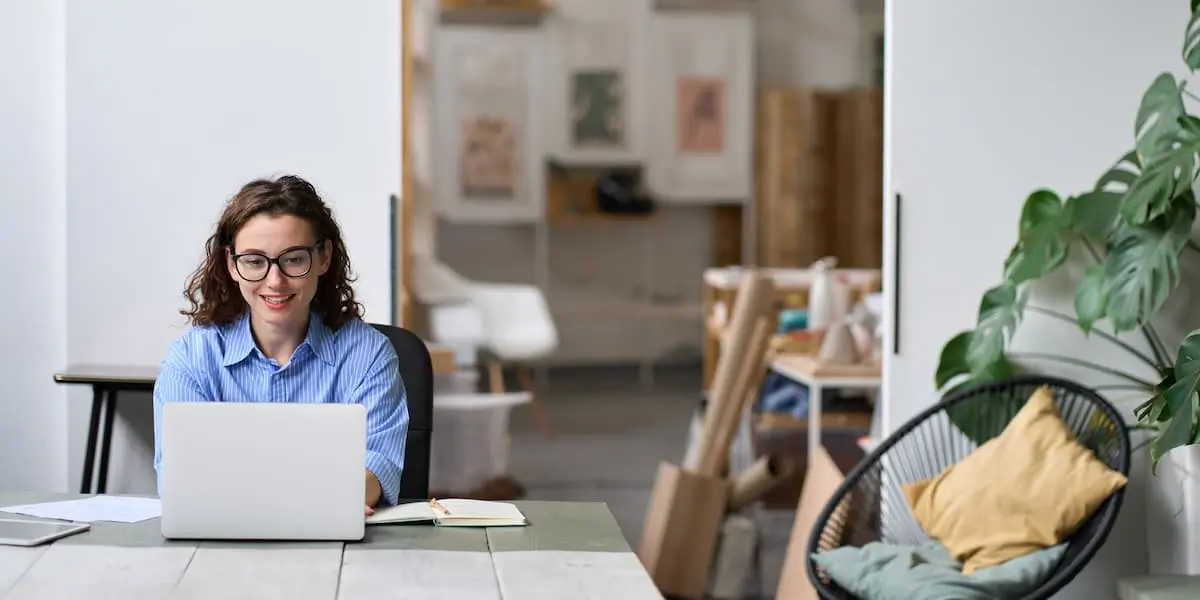 a tech worker researches the best work from home jobs at her laptop