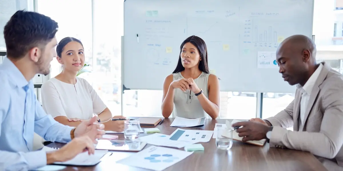 An agile team in a sprint review meeting in an office.