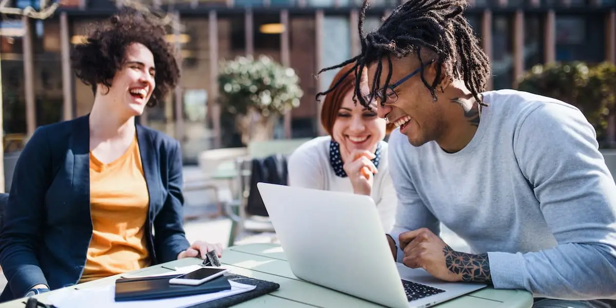 group of young businesspeople take a career test on a laptop