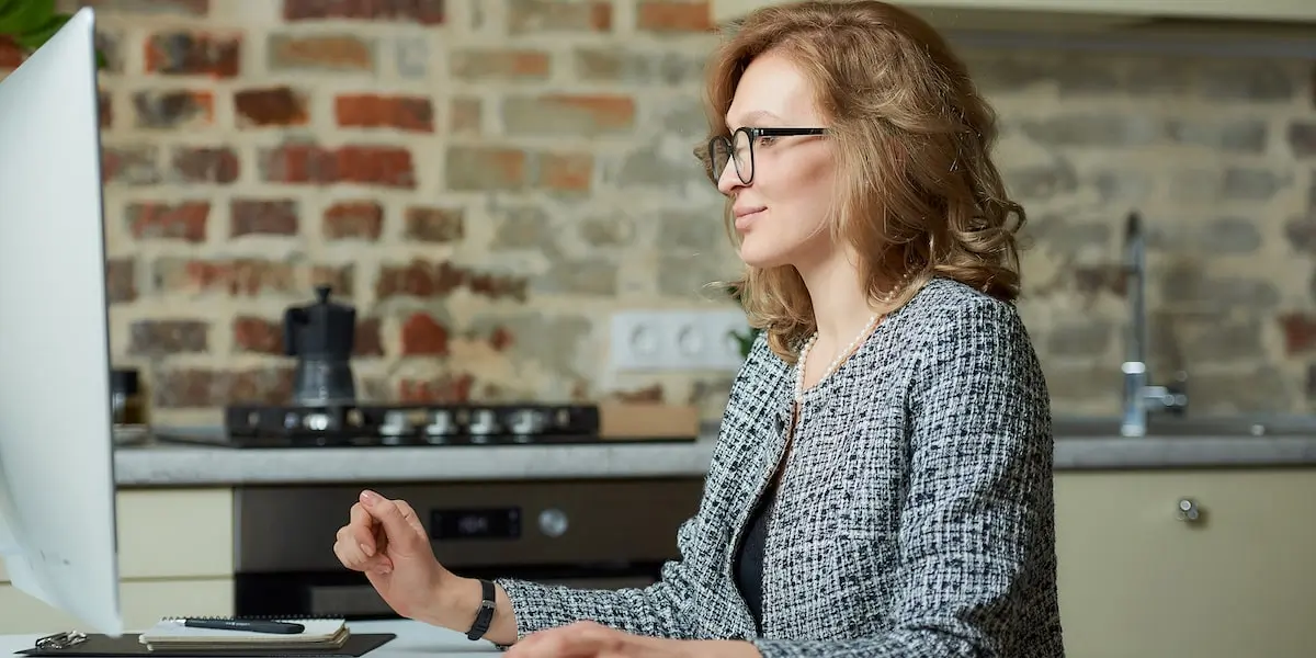 A woman earning a computer programmer salary sits in her home office coding.